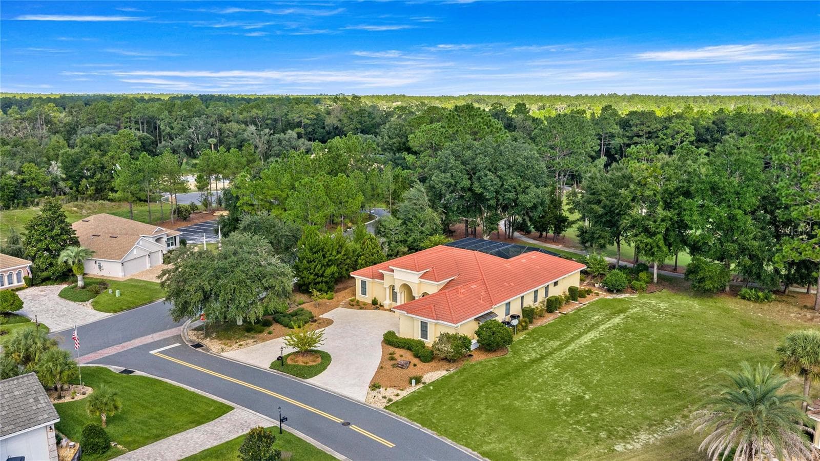 Spectacular aerial view showcasing the home's spacious setting, circular driveway, mature trees, and proximity to beautifully maintained golf course fairways. - 6501 SW 179TH AVENUE RD, DUNNELLON