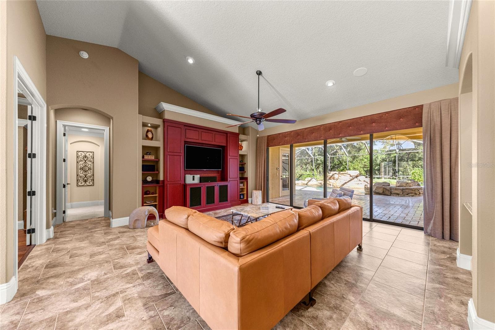 Open living space featuring custom entertainment wall. - 6501 SW 179TH AVENUE RD, DUNNELLON