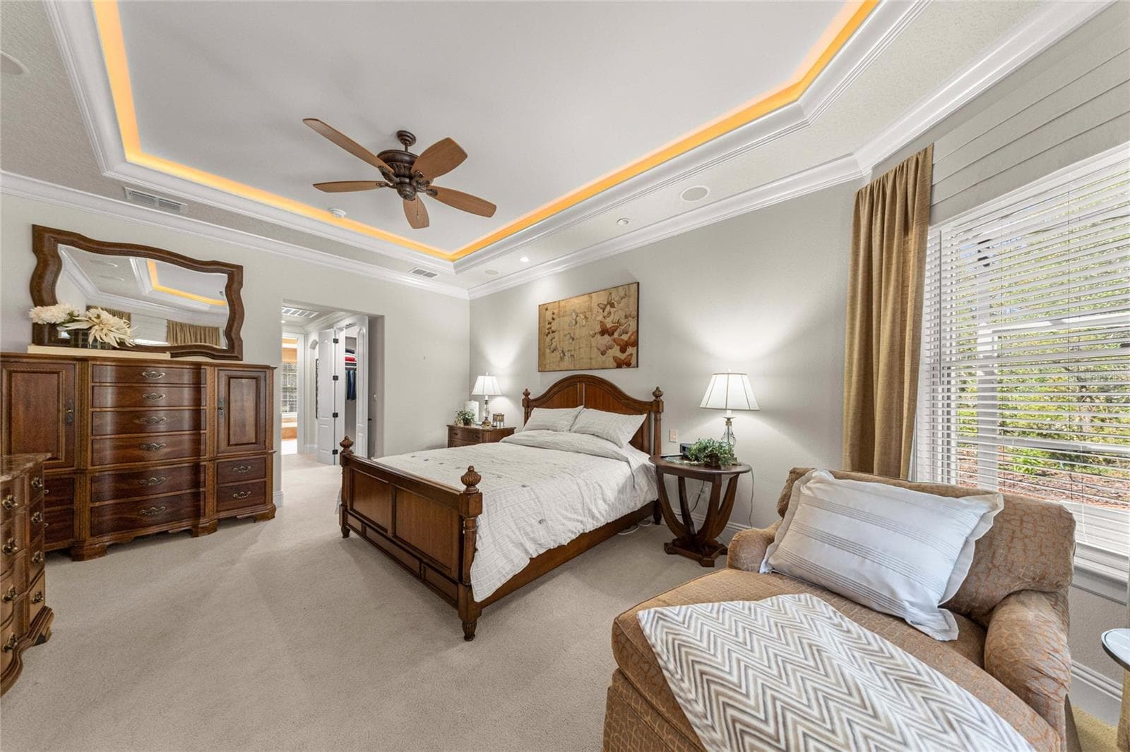 Beautiful owner's retreat offering generous space, a sitting area, and a distinctive illuminated tray ceiling. - 6501 SW 179TH AVENUE RD, DUNNELLON