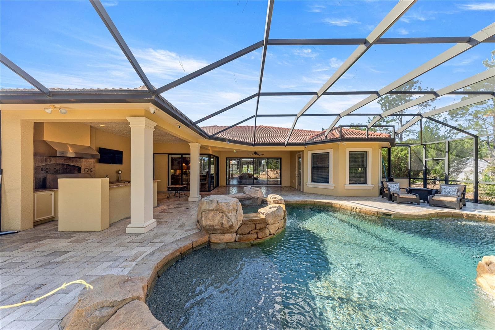 Screened Pool Area – Large screened enclosure with paver decking and views of the pool. - 6501 SW 179TH AVENUE RD, DUNNELLON