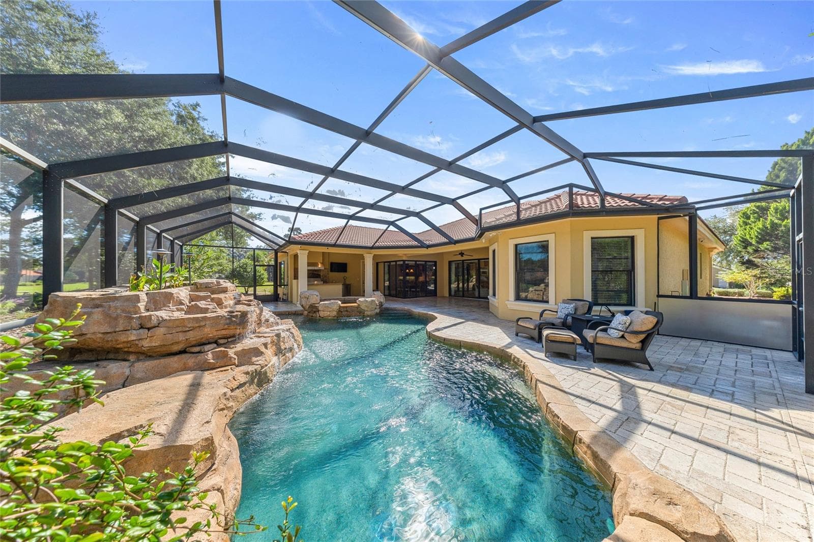 Screened Pool Enclosure – Expansive screened outdoor living area surrounded by natural landscaping. - 6501 SW 179TH AVENUE RD, DUNNELLON