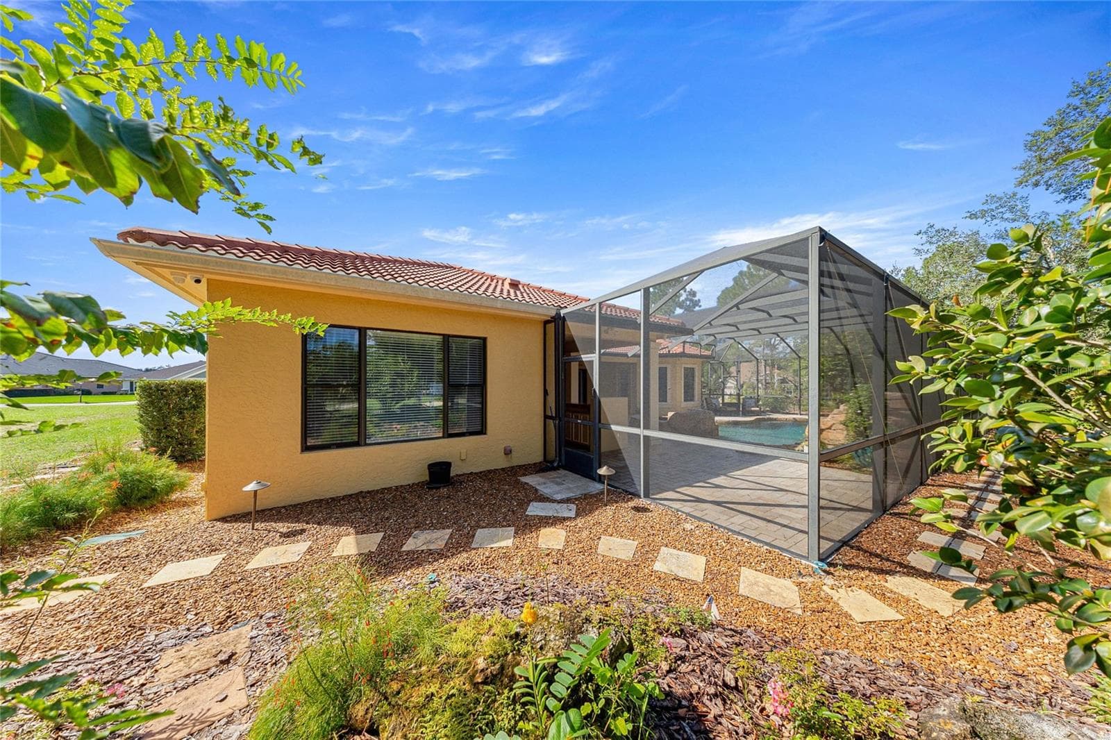 Screened Pool Enclosure – Expansive screened outdoor living area surrounded by natural landscaping. - 6501 SW 179TH AVENUE RD, DUNNELLON