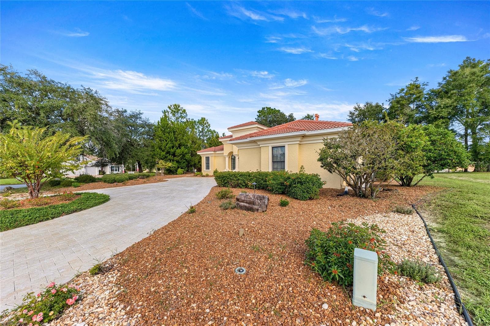 xterior View – Mediterranean-style home surrounded by mature landscaping and a spacious driveway. - 6501 SW 179TH AVENUE RD, DUNNELLON