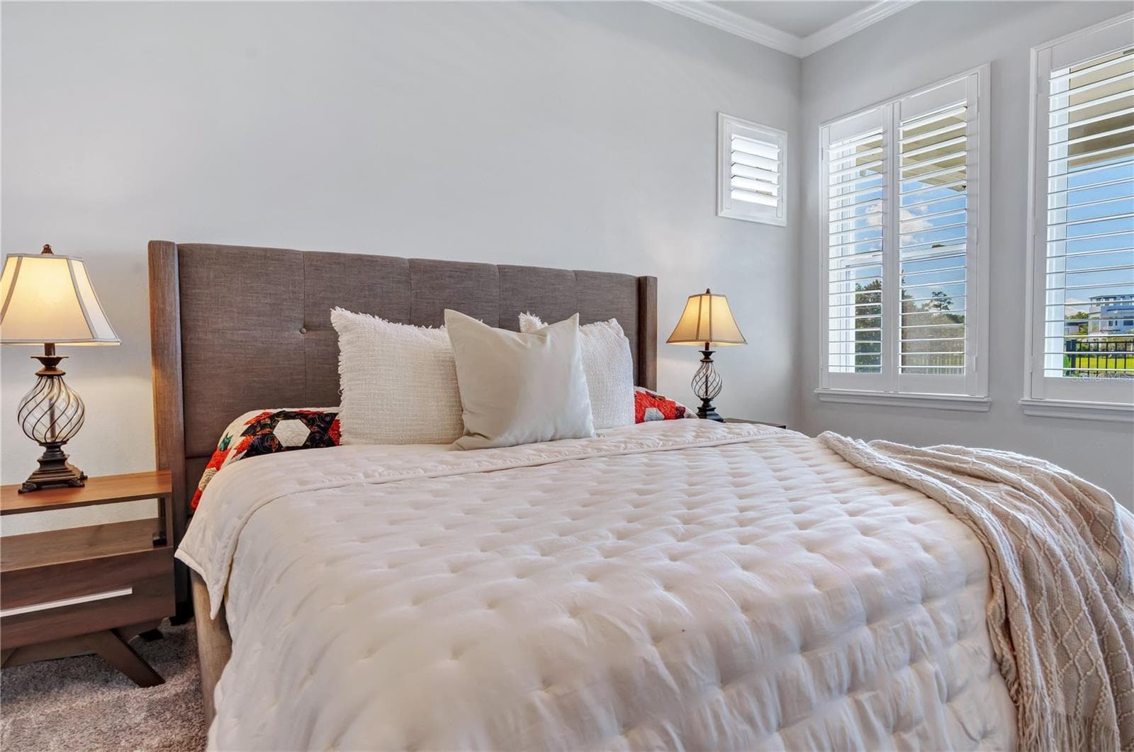Primary bedroom retreat with room for a king bed and sitting area, plush carpet, and plantation shutters. - 8336 CANETTI ST, ORLANDO