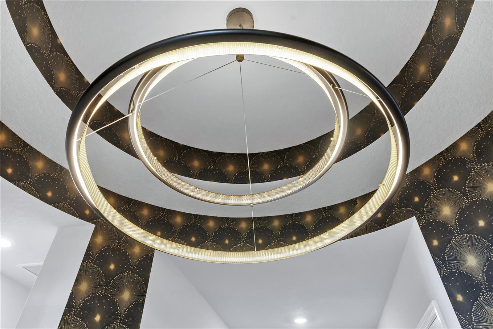 Statement circular chandelier set within an accent tray ceiling. Designer details throughout this Laureate Park home. - 8336 CANETTI ST, ORLANDO