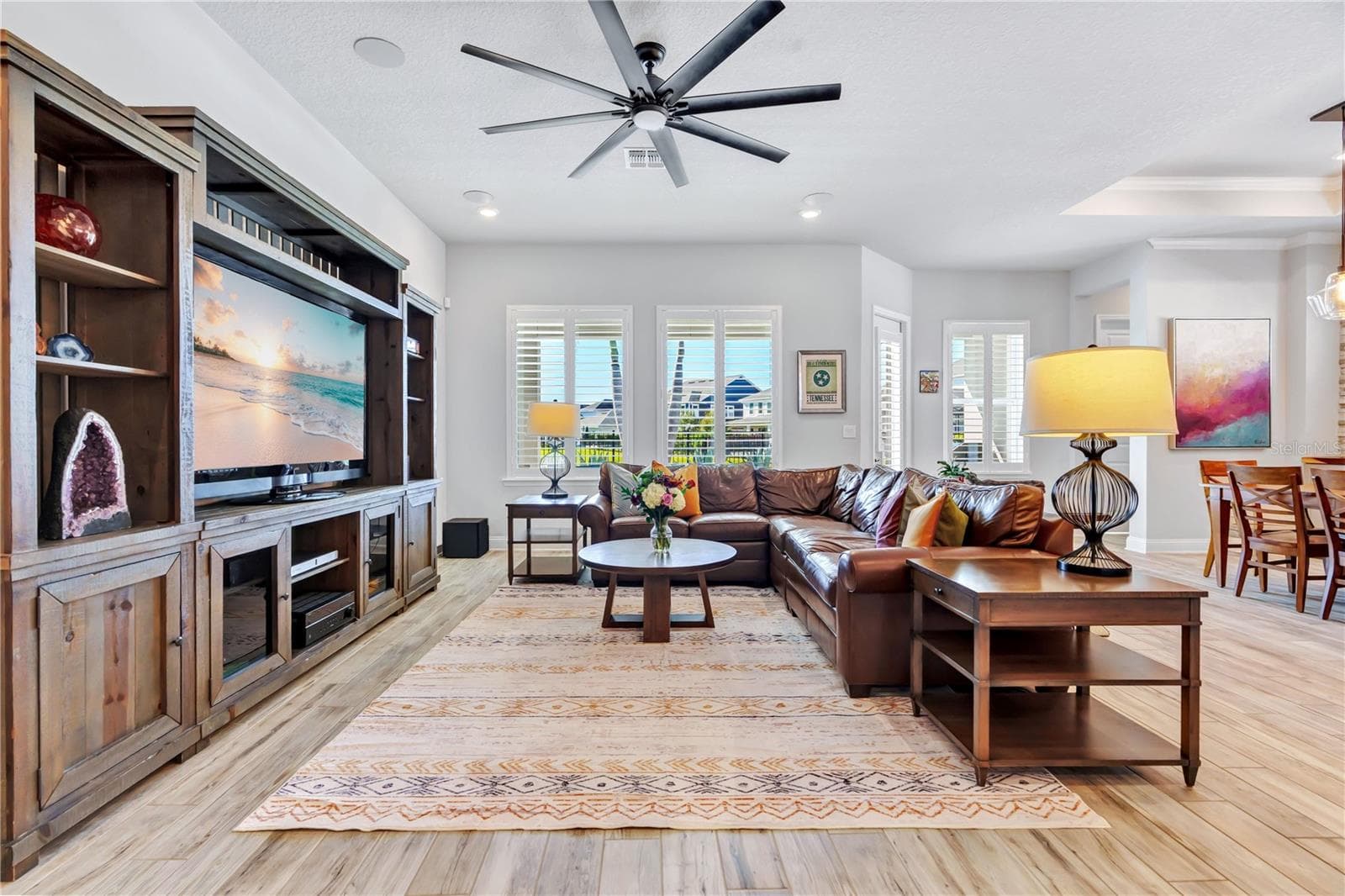 Family room with custom built in entertainment center and an easy connection to the kitchen and dining area. - 8336 CANETTI ST, ORLANDO