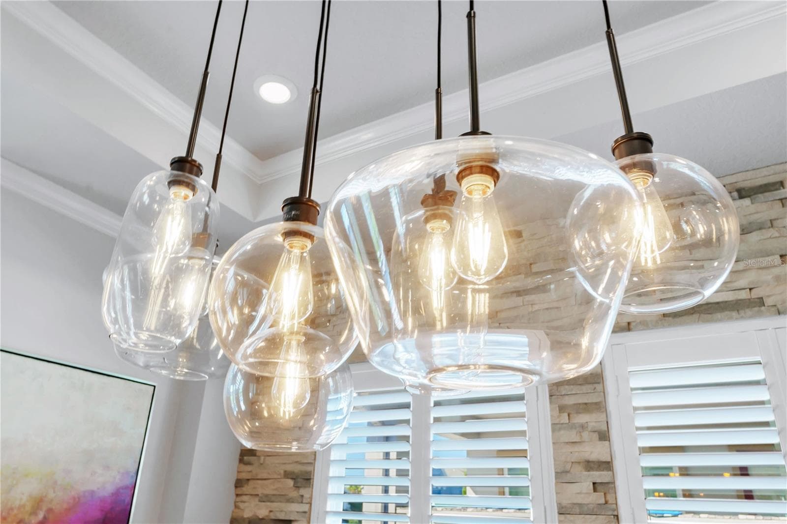 Designer glass pendant lights over the dining table add warmth and style. - 8336 CANETTI ST, ORLANDO
