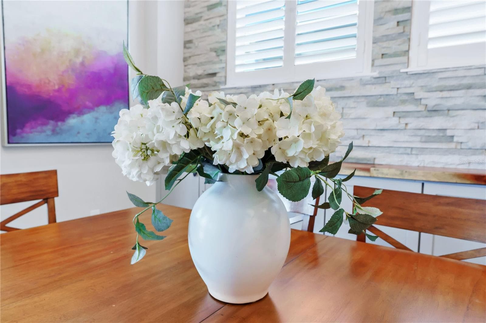 Thoughtful finishes and natural light create a warm, welcoming dining space. - 8336 CANETTI ST, ORLANDO