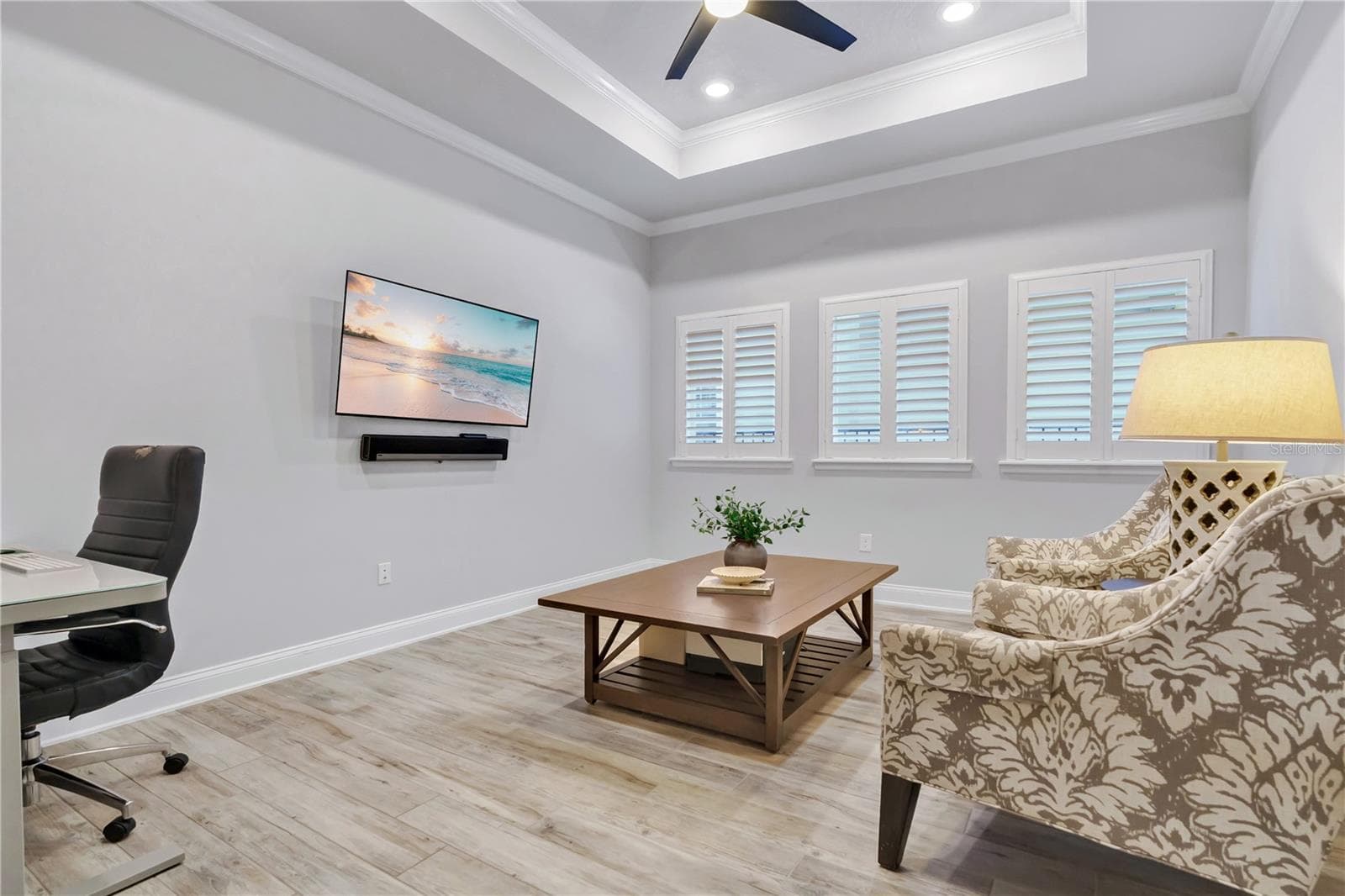 Flex room with tray ceiling and plantation shutters, ready for media, work, or guests. - 8336 CANETTI ST, ORLANDO