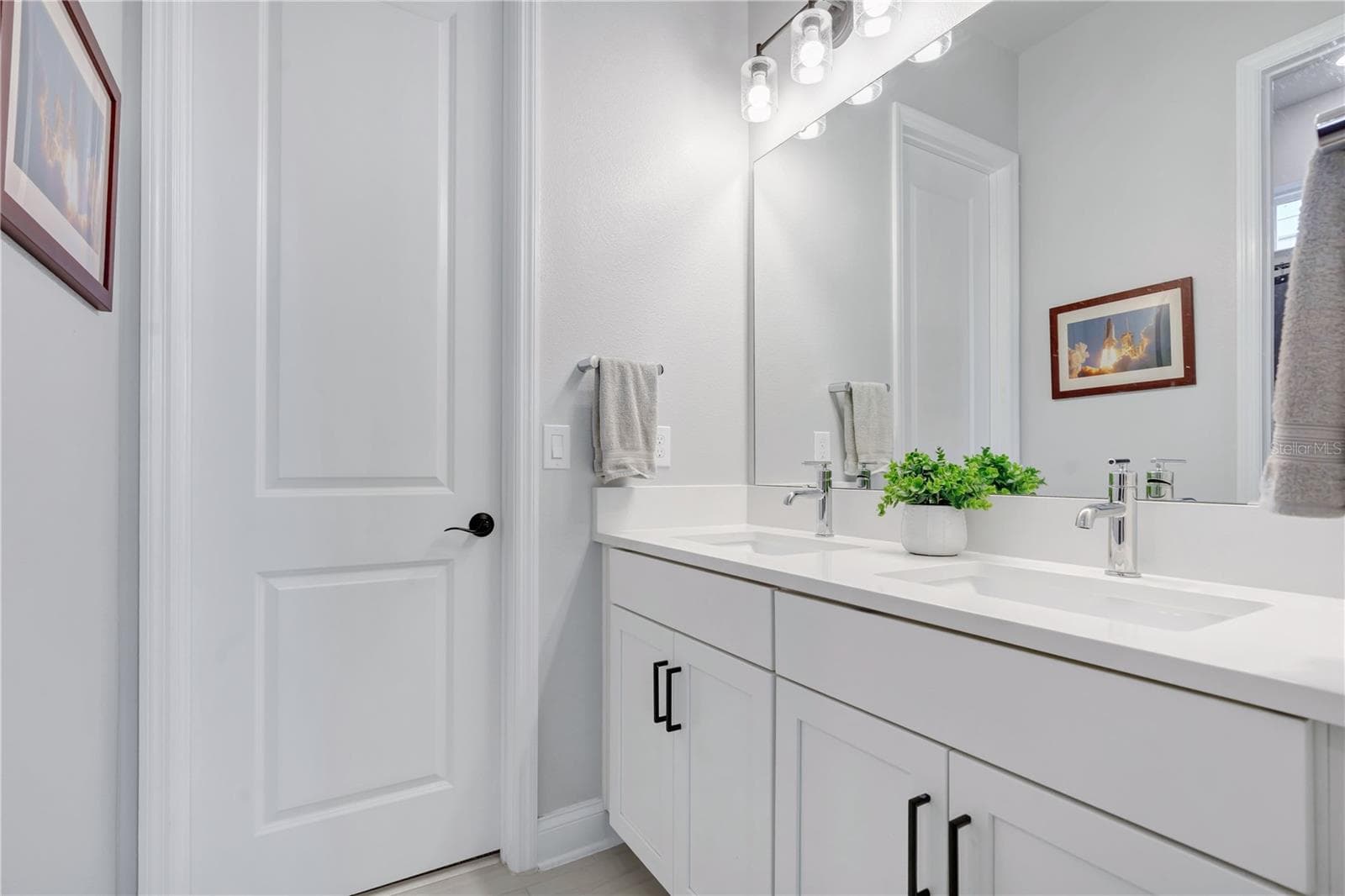 Full guest bath with quartz vanity, framed mirror, and modern fixtures. - 8336 CANETTI ST, ORLANDO