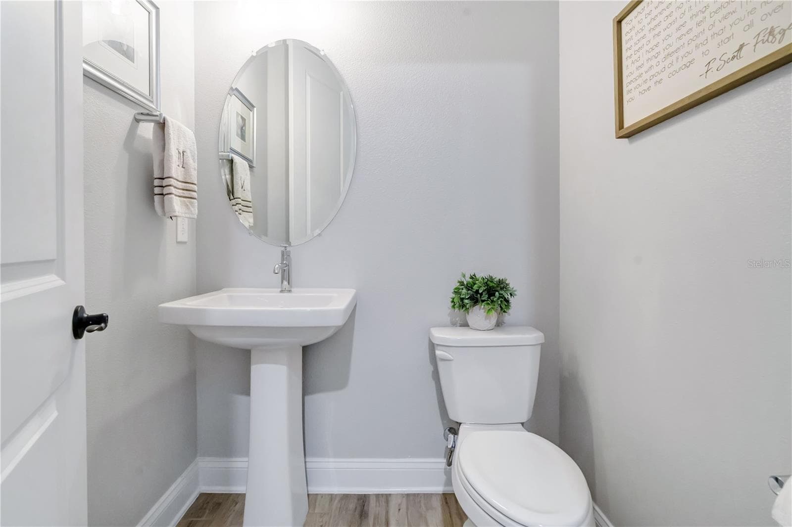 Convenient half bath with pedestal sink and modern finishes. - 8336 CANETTI ST, ORLANDO