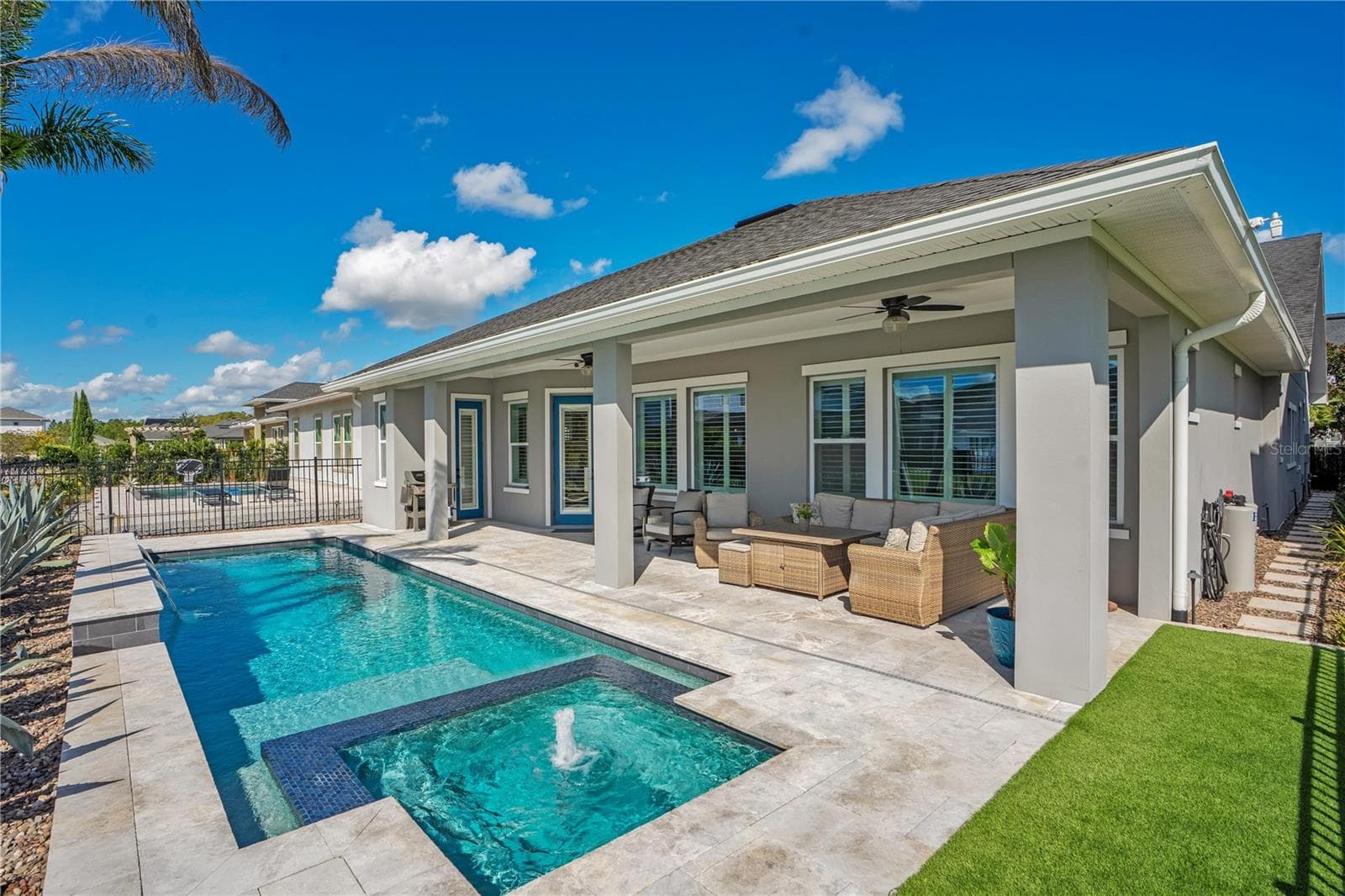 Rear exterior with private heated salt water pool and covered extended lanai. Florida outdoor living in Lake Nona, Orlando. - 8336 CANETTI ST, ORLANDO