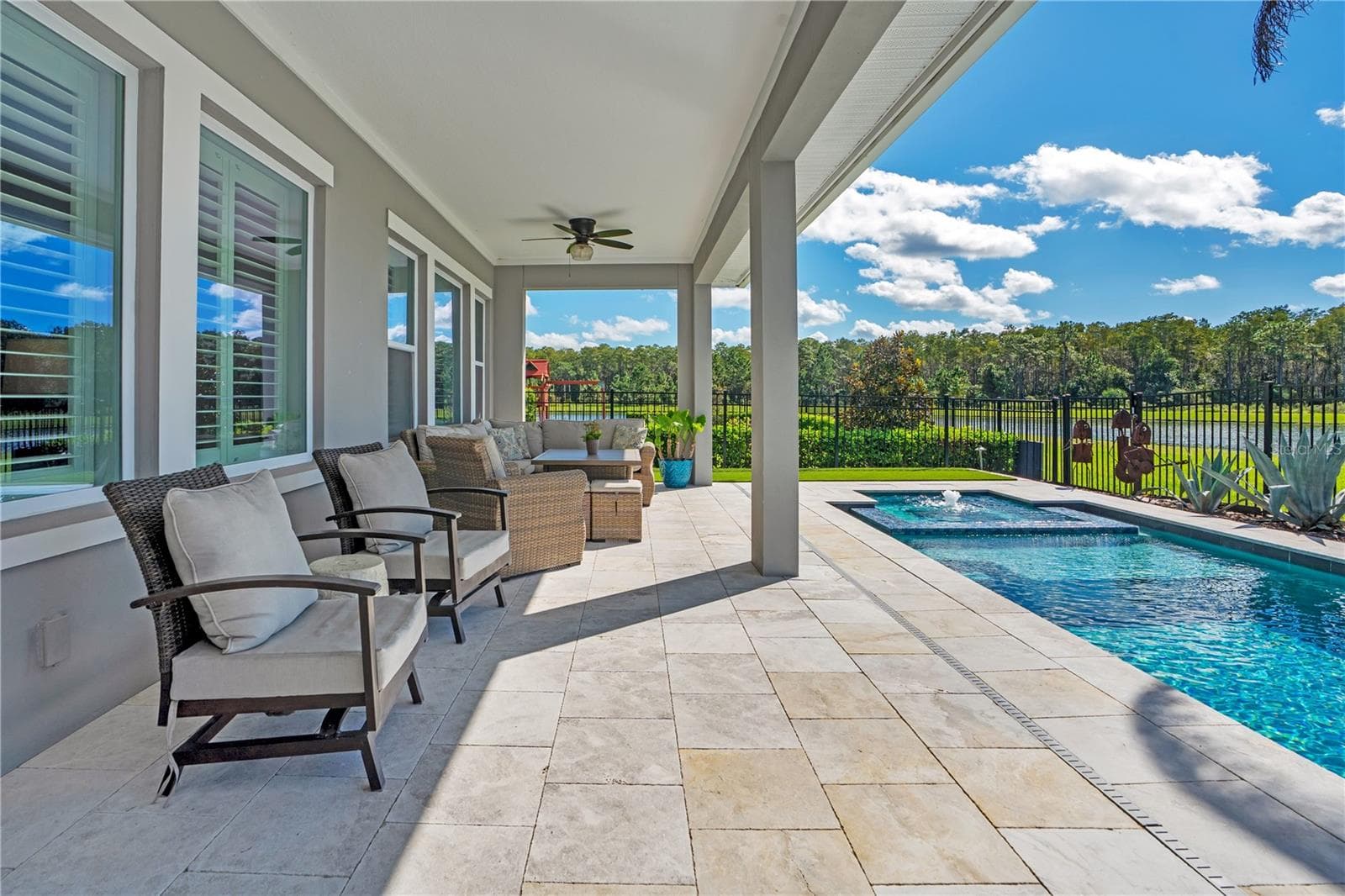 Extended covered lanai overlooking the pool and water and conservation view. Pre wired for surround sound. - 8336 CANETTI ST, ORLANDO