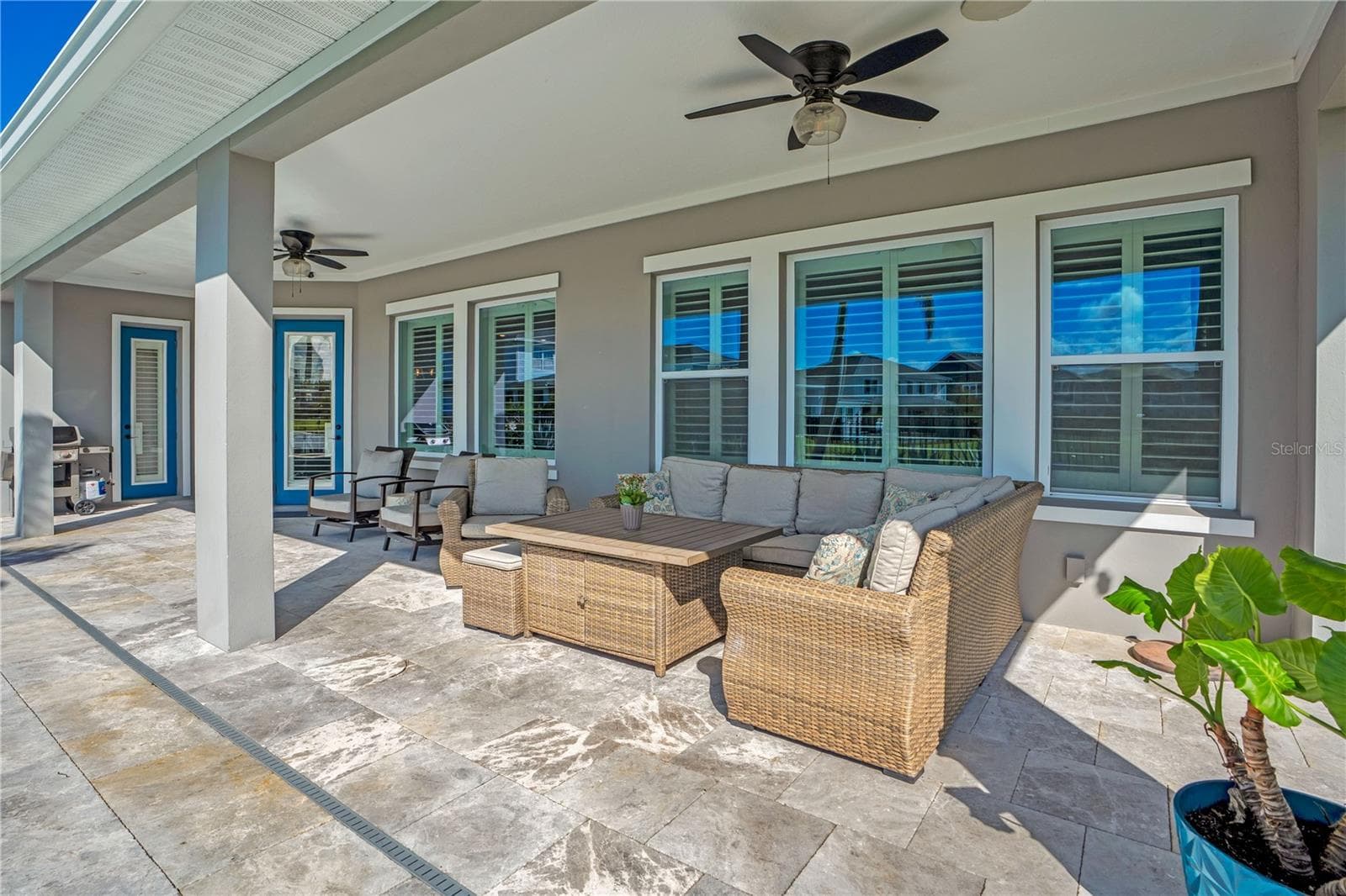 Covered lanai lounge with ceiling fan, perfect for relaxing year round in Central Florida. - 8336 CANETTI ST, ORLANDO