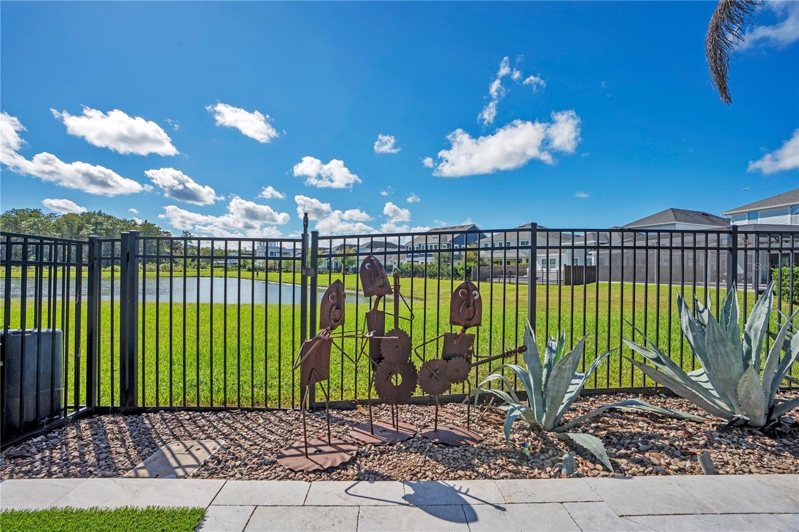 Fenced backyard opening to a water and conservation view behind the home. - 8336 CANETTI ST, ORLANDO