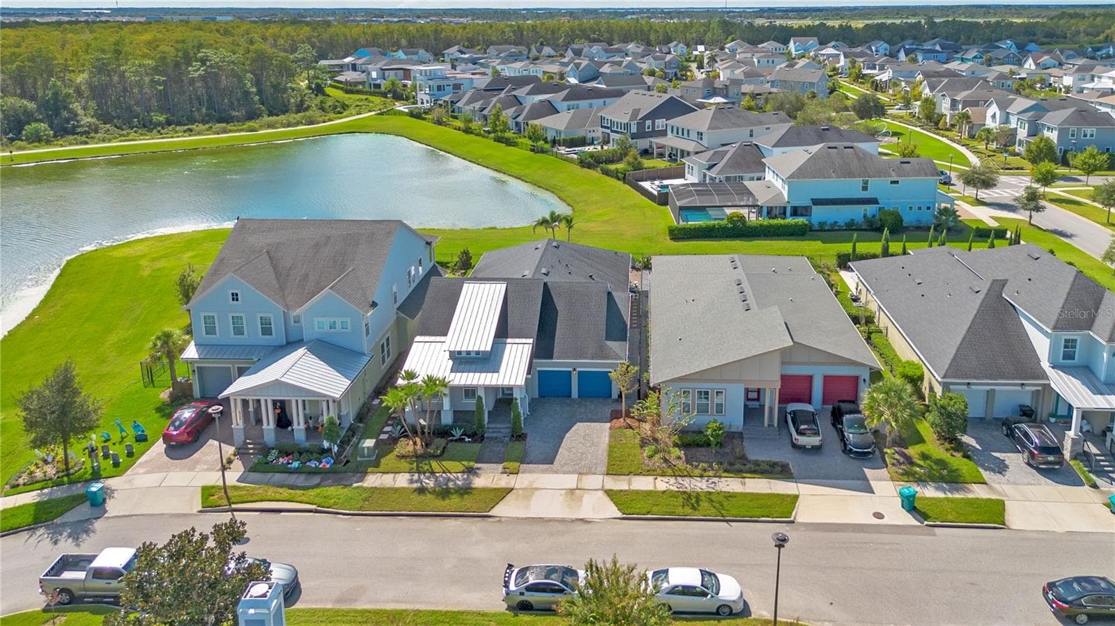 Aerial of the home along the pond with water and conservation views. - 8336 CANETTI ST, ORLANDO