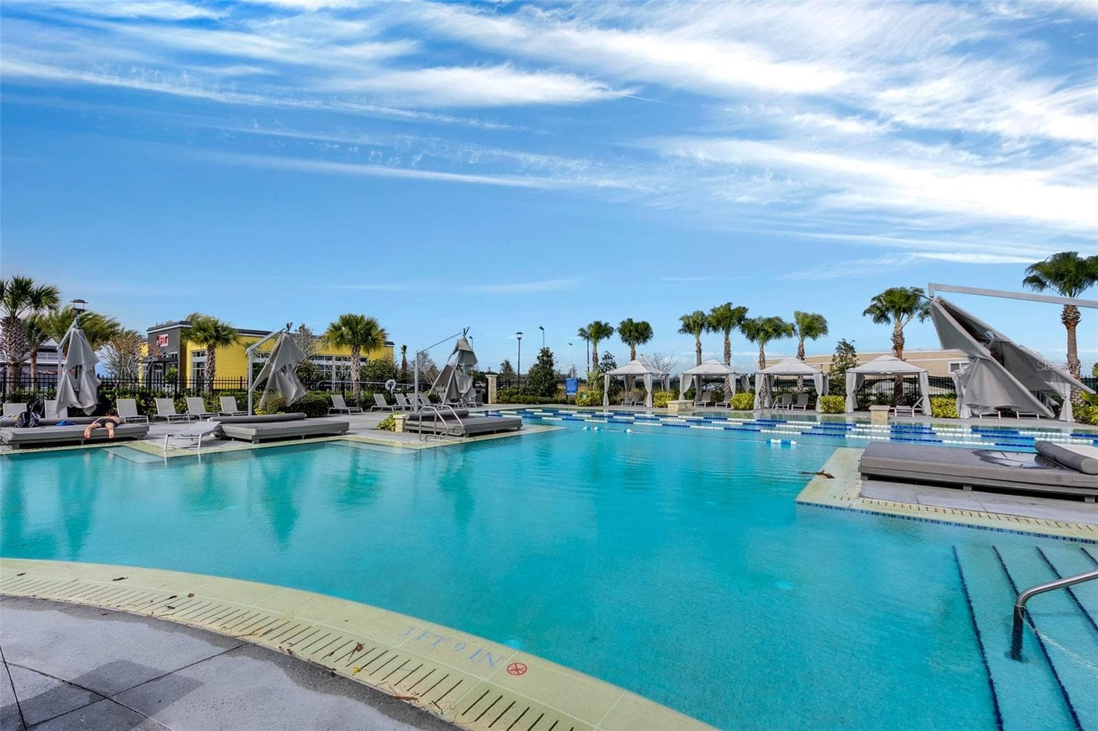 Sparkling community pool with water slide and sun deck, an everyday resort experience in Lake Nona. - 8336 CANETTI ST, ORLANDO