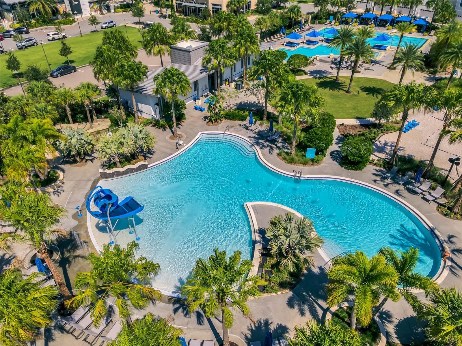 Community resort style pool with lush landscaping and lounge areas. - 8336 CANETTI ST, ORLANDO