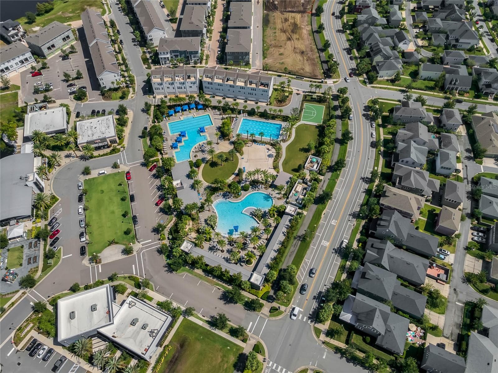 Community pool complex surrounded by walkable neighborhood streets in Lake Nona. - 8336 CANETTI ST, ORLANDO