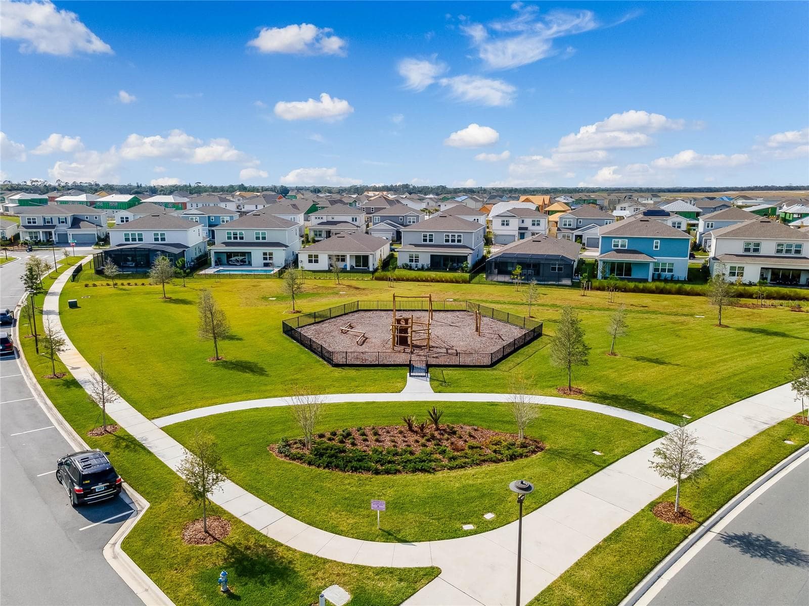 Landscaped neighborhood park with winding walking paths in Laureate Park. - 8336 CANETTI ST, ORLANDO