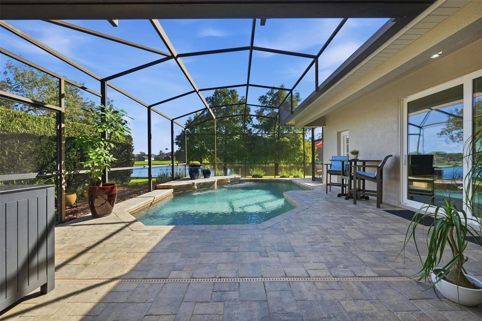 VIEW OF THE POOL, POND, CYPRESS TREES AND CONSERVATION. NO REAR NEIGHBORS! - 13850 BLUEWATER CIR, ORLANDO