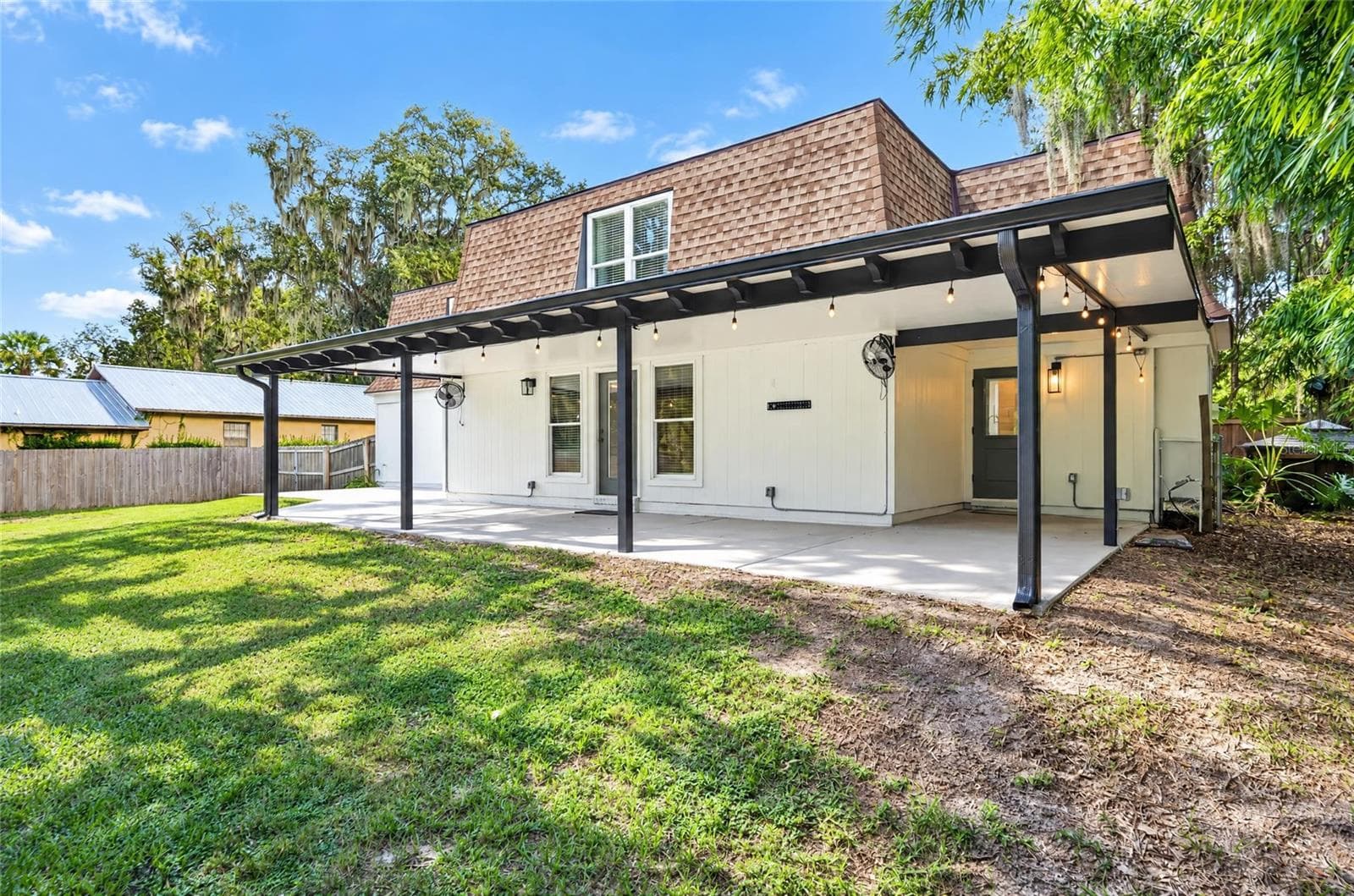 Covered Patio with gutters, lighting, and fans - 1333 SE 3RD ST, OCALA