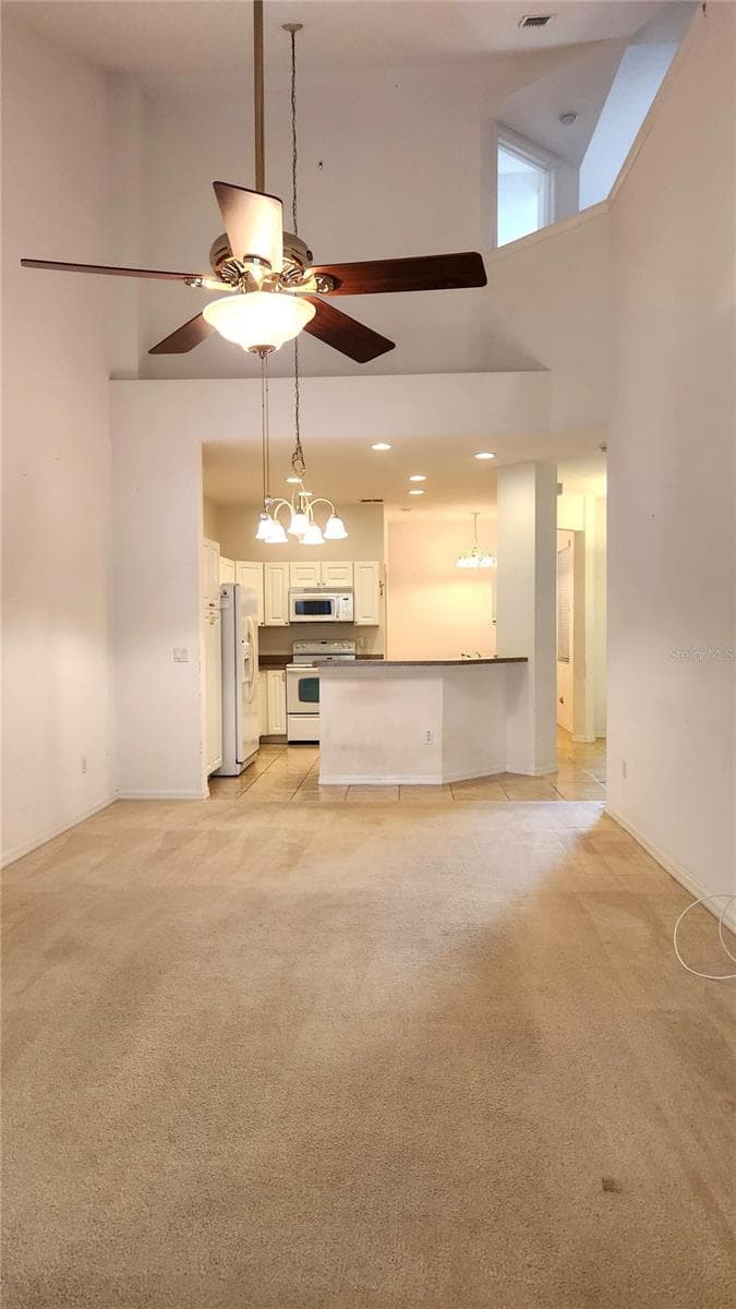 View from Living Room into Kitchen. - 642 SPRING LAKE CIR, TARPON SPRINGS