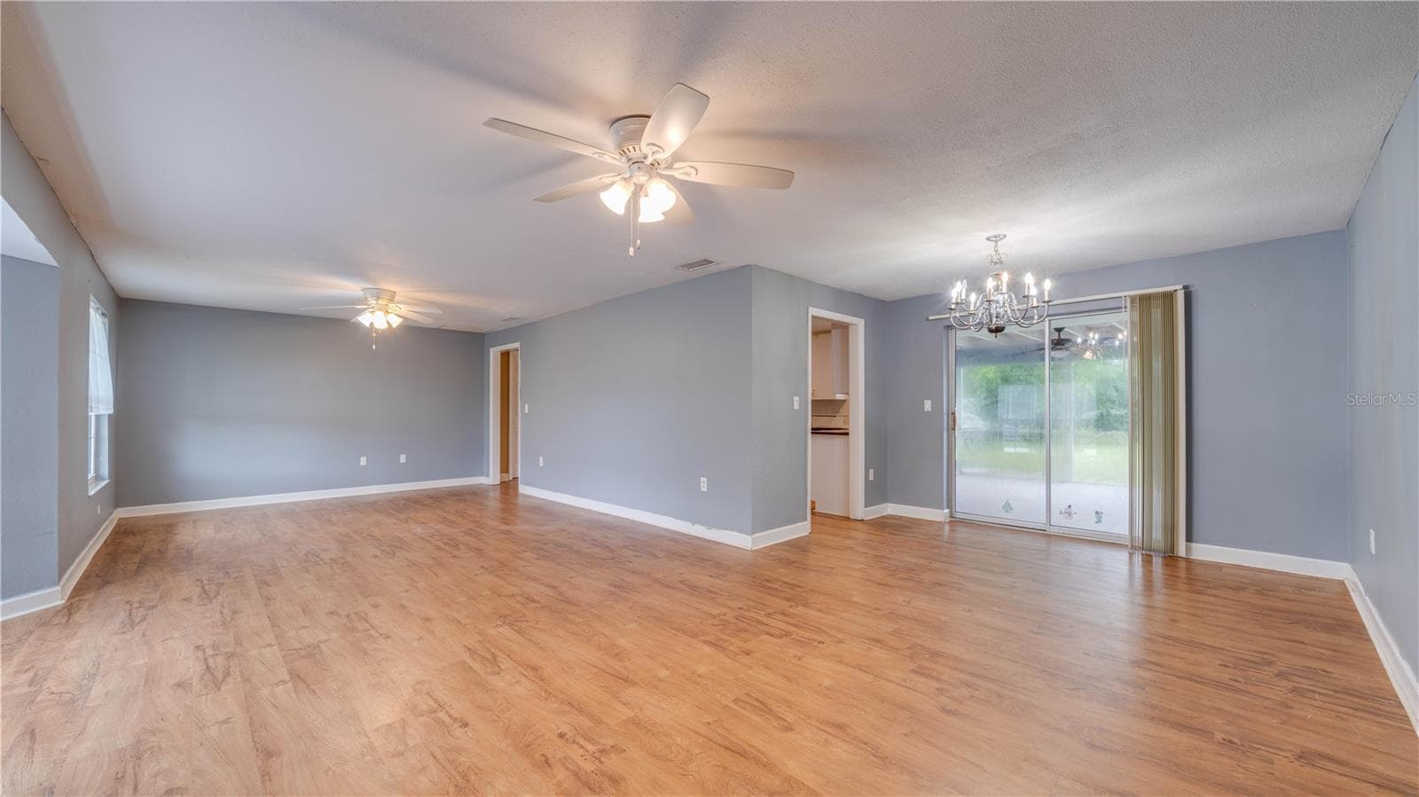 An expansive family room and a designated dining area. - 909 SE 27TH ST, CAPE CORAL