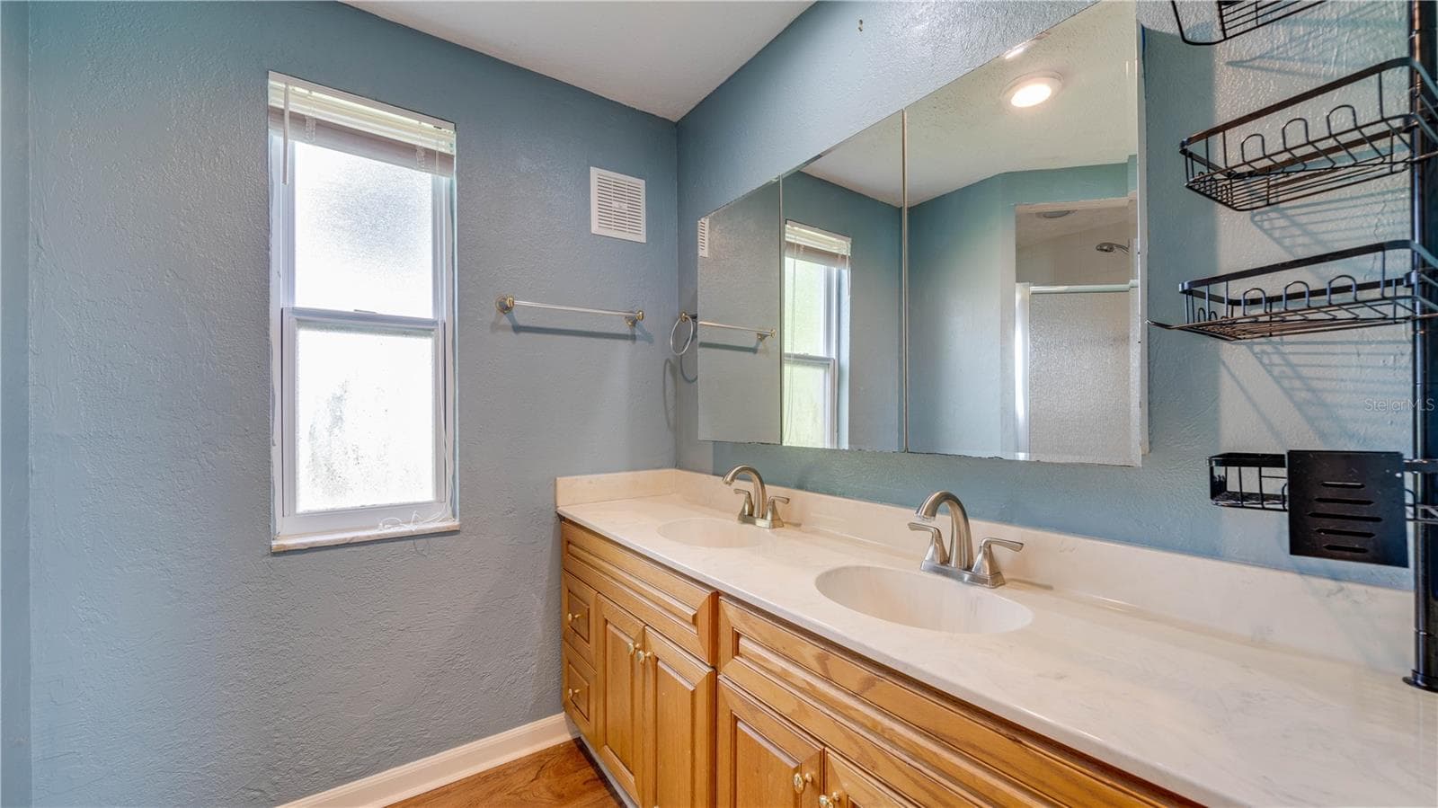 Primary Bath offers dual sinks, a walk-in shower, and brushed nickel fixtures. - 909 SE 27TH ST, CAPE CORAL