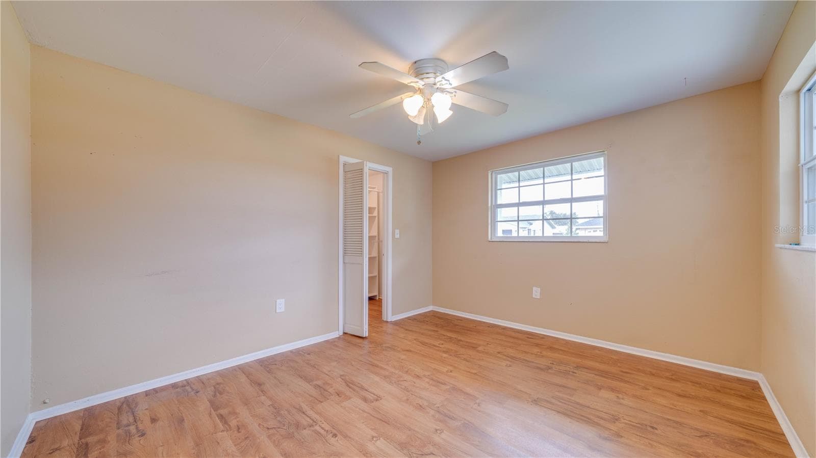 Bedroom No. 2 also features a walk-in closet and LVT flooring. - 909 SE 27TH ST, CAPE CORAL
