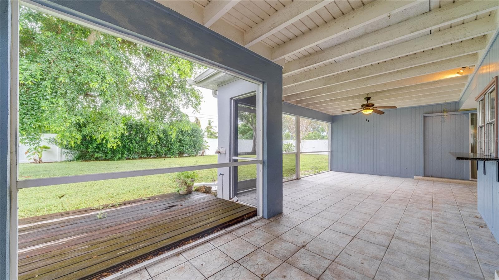 The oversized, tiled lanai showcases an exposed beam ceiling and so much room for your outdoor oasis. - 909 SE 27TH ST, CAPE CORAL