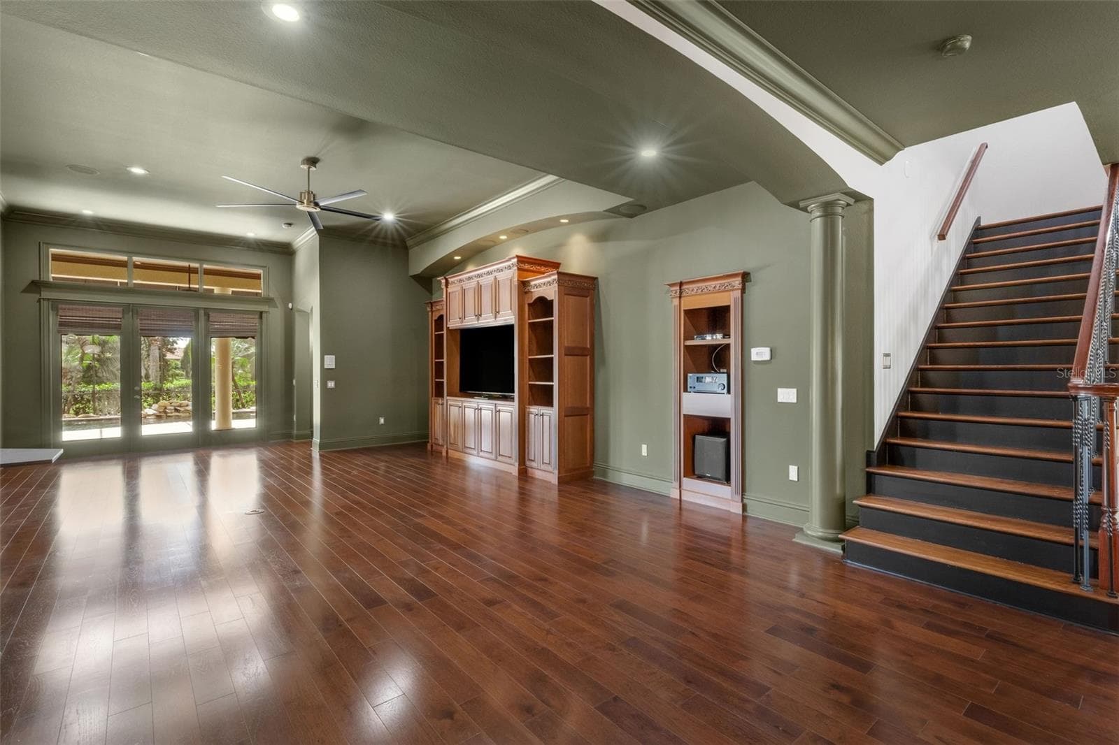 The massive greatroom features a built-in entertainment center and space for equipment elements that support the whole house sound system. - 2734 BELLERIVE DR, LAKELAND
