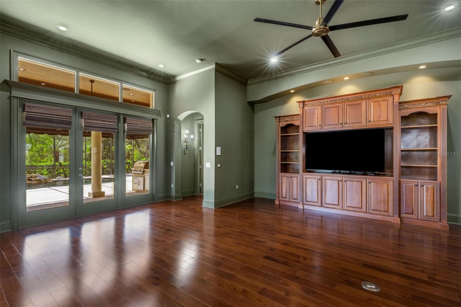 This space features a full bank of glass doors leading to the lanai and pool area. - 2734 BELLERIVE DR, LAKELAND