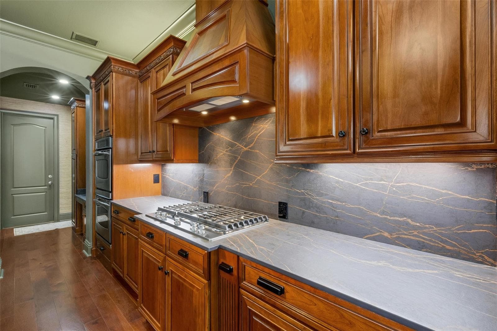 The six-burner gas cooktop, built-in ovens, built-in GE Monogram refrigerator are just icing on the cake. - 2734 BELLERIVE DR, LAKELAND