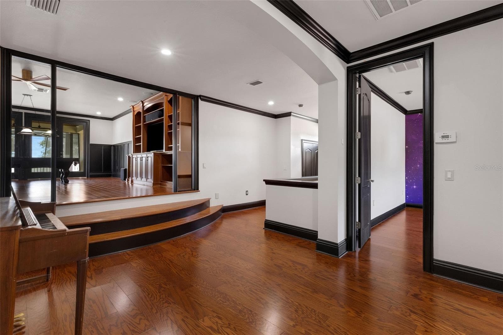 At the top of the stairway is an open common area leading to the elevated 19' x 25' game room. - 2734 BELLERIVE DR, LAKELAND
