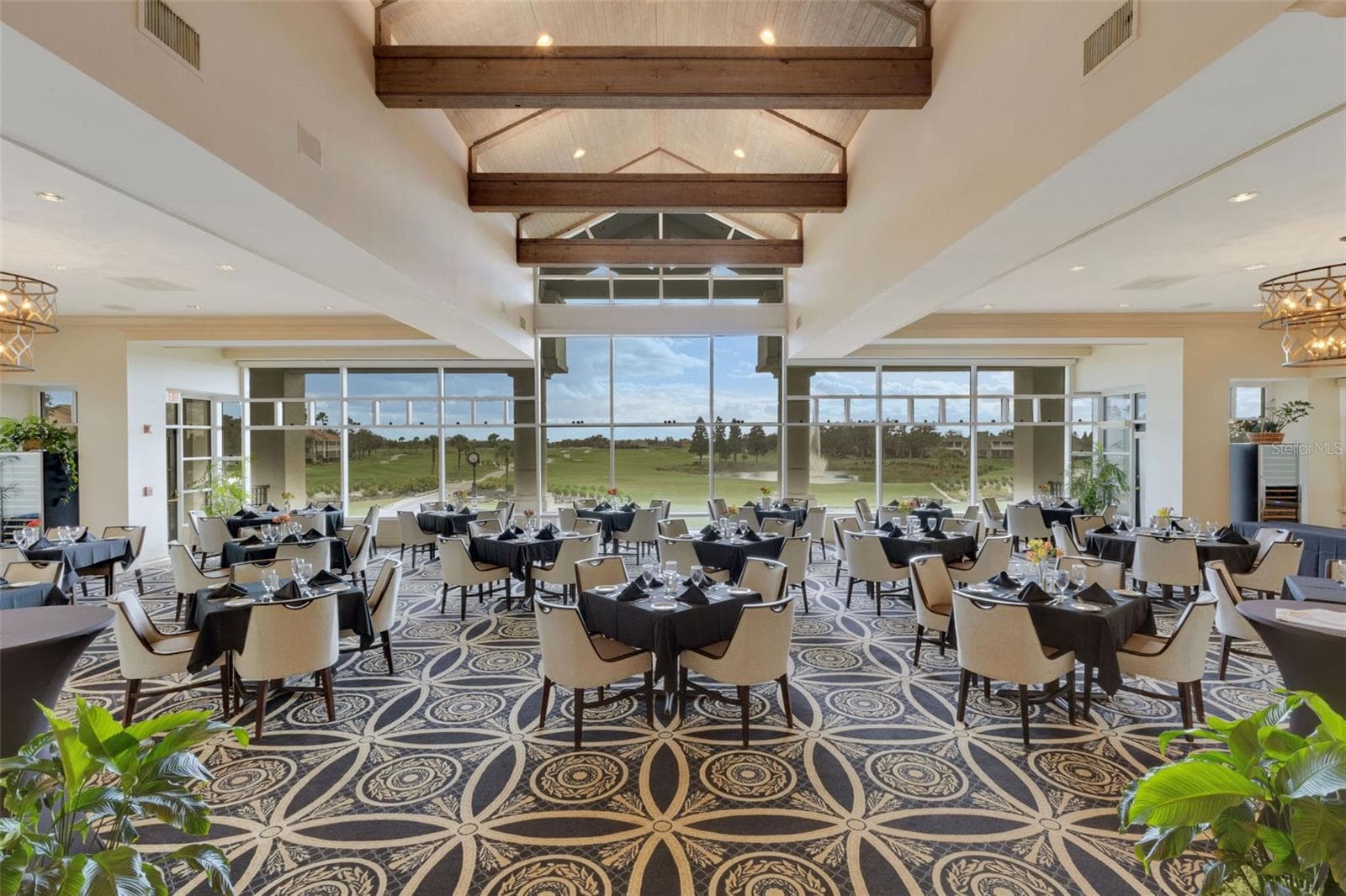 The elegant main dining room has stunning panoramic views of the golf course beyond. - 2734 BELLERIVE DR, LAKELAND