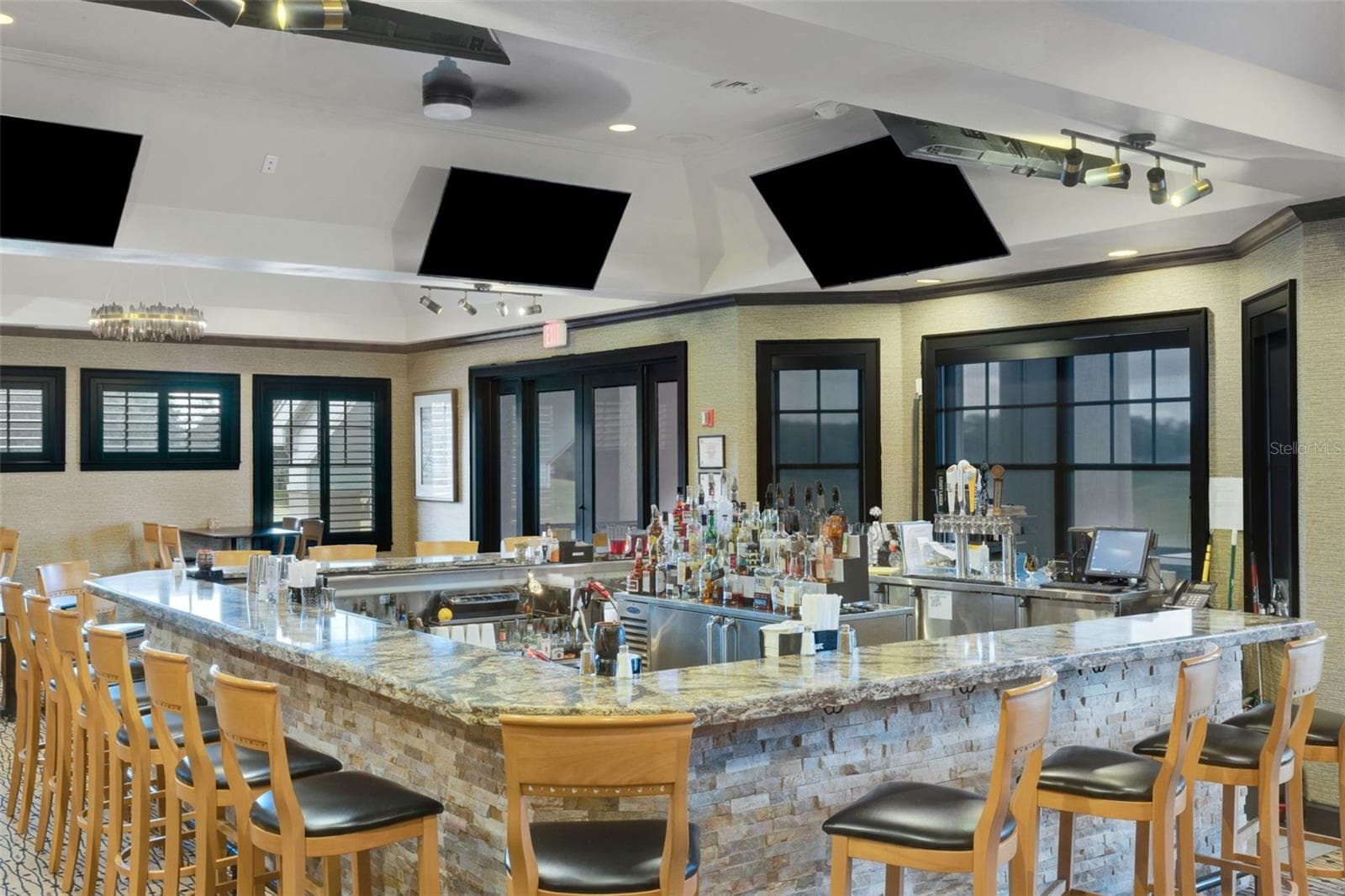 And the U-Shaped Bar features a view and sports on TV at the same time. - 2734 BELLERIVE DR, LAKELAND