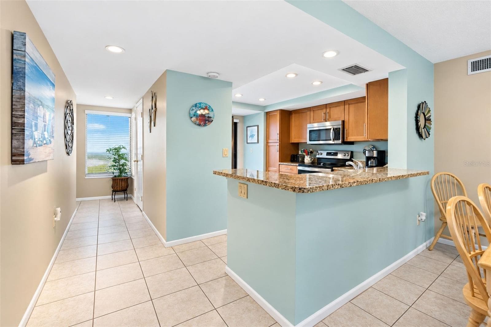 The kitchen features tiled flooring and a high top breakfast bar. - 2950 N BEACH RD #A321, ENGLEWOOD