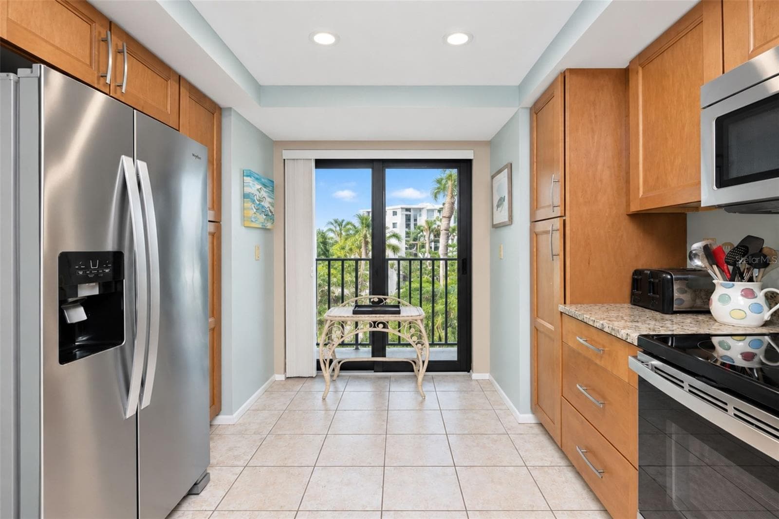 The kitchen has a stainless steel double door Whirlpool refrigerator and a French balony. - 2950 N BEACH RD #A321, ENGLEWOOD