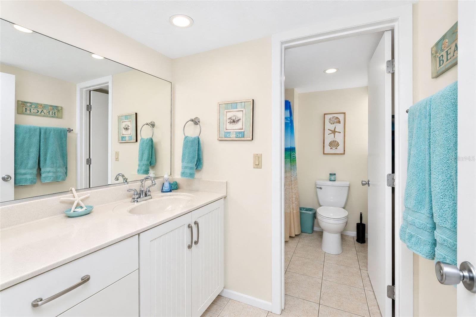 The guest bathroom features tiled flooring and an updated solid surface countertop vanity. - 2950 N BEACH RD #A321, ENGLEWOOD
