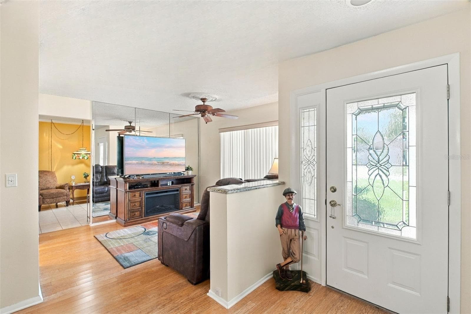 Living room conveniently tucked between the dining room & kitchen~ - 1743 MACDONNELL DR, PALM HARBOR