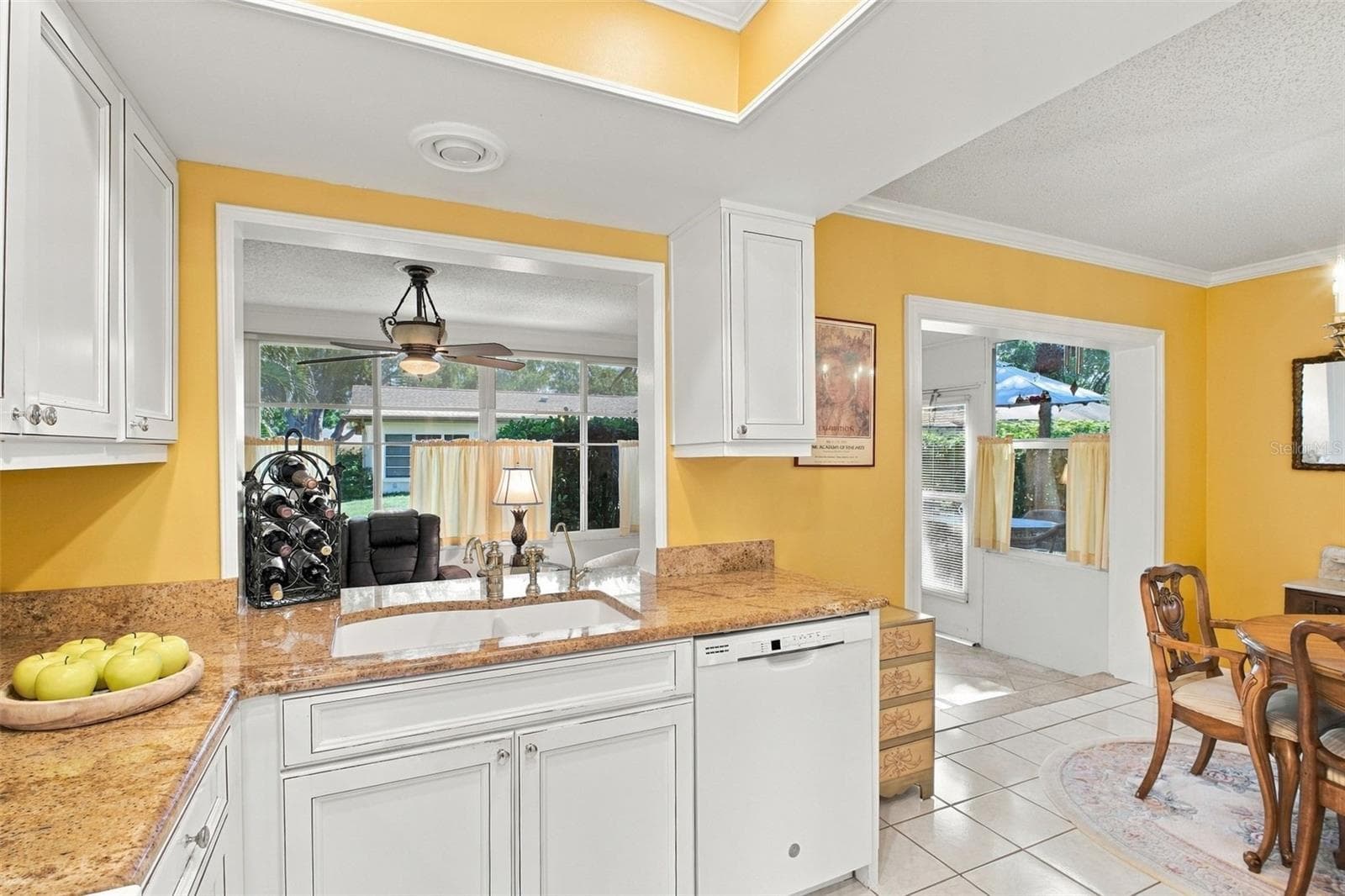 Convenient pass-through window to the Florida room making entertaining a breeze~ - 1743 MACDONNELL DR, PALM HARBOR