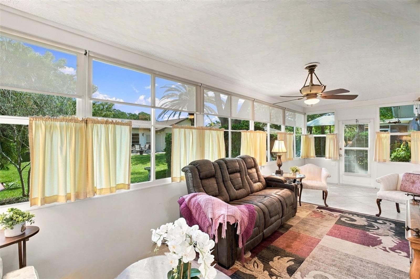 Massive Florida room located at the rear of the home surrounded by large windows with peaceful green views~ - 1743 MACDONNELL DR, PALM HARBOR