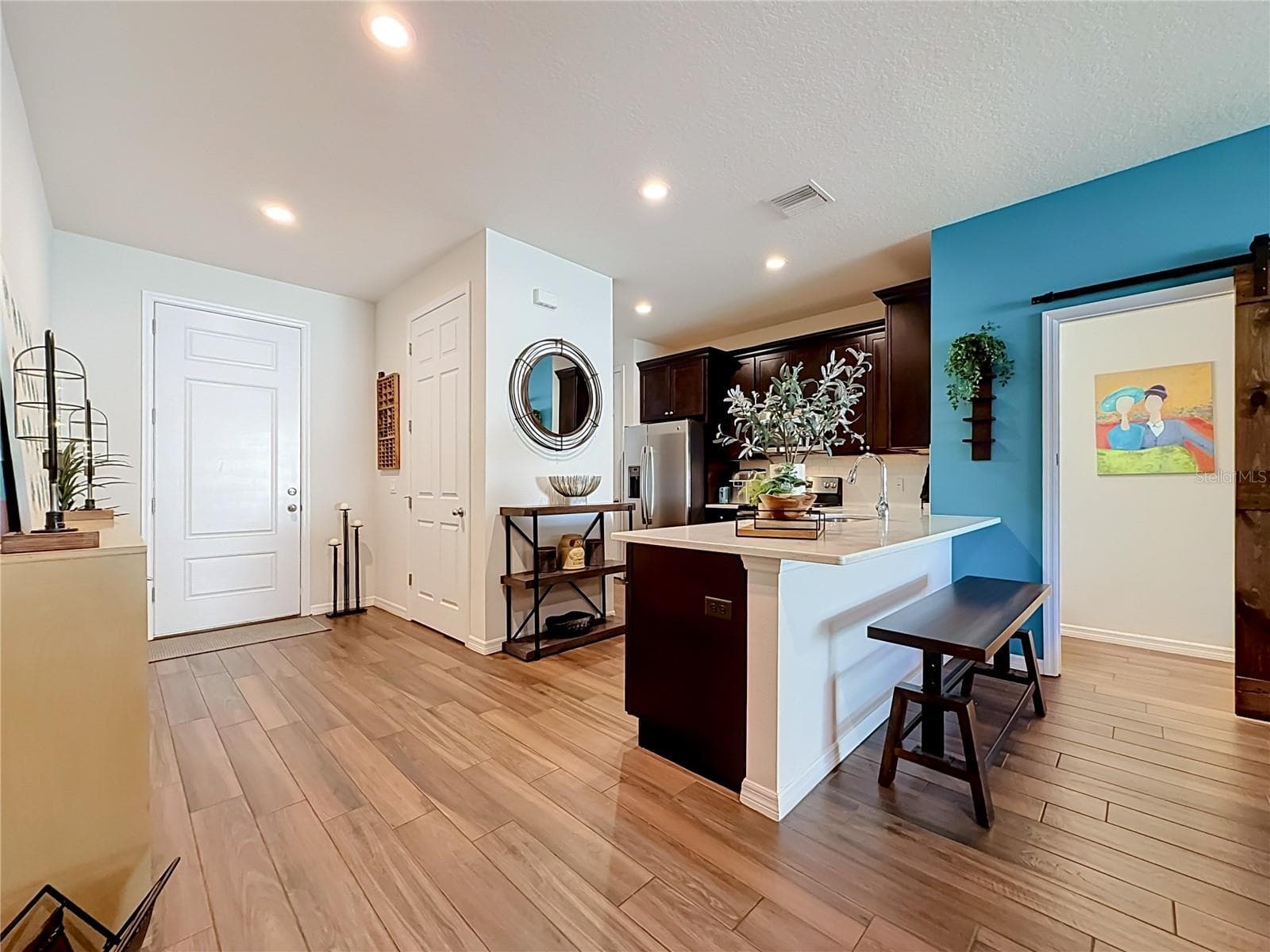 Step inside to discover a spacious OPEN FLOOR PLAN with soaring ceilings and beautiful WOOD-LOOK TILE flooring throughout the downstairs living areas. - 2270 MONTVIEW DR, CLEARWATER