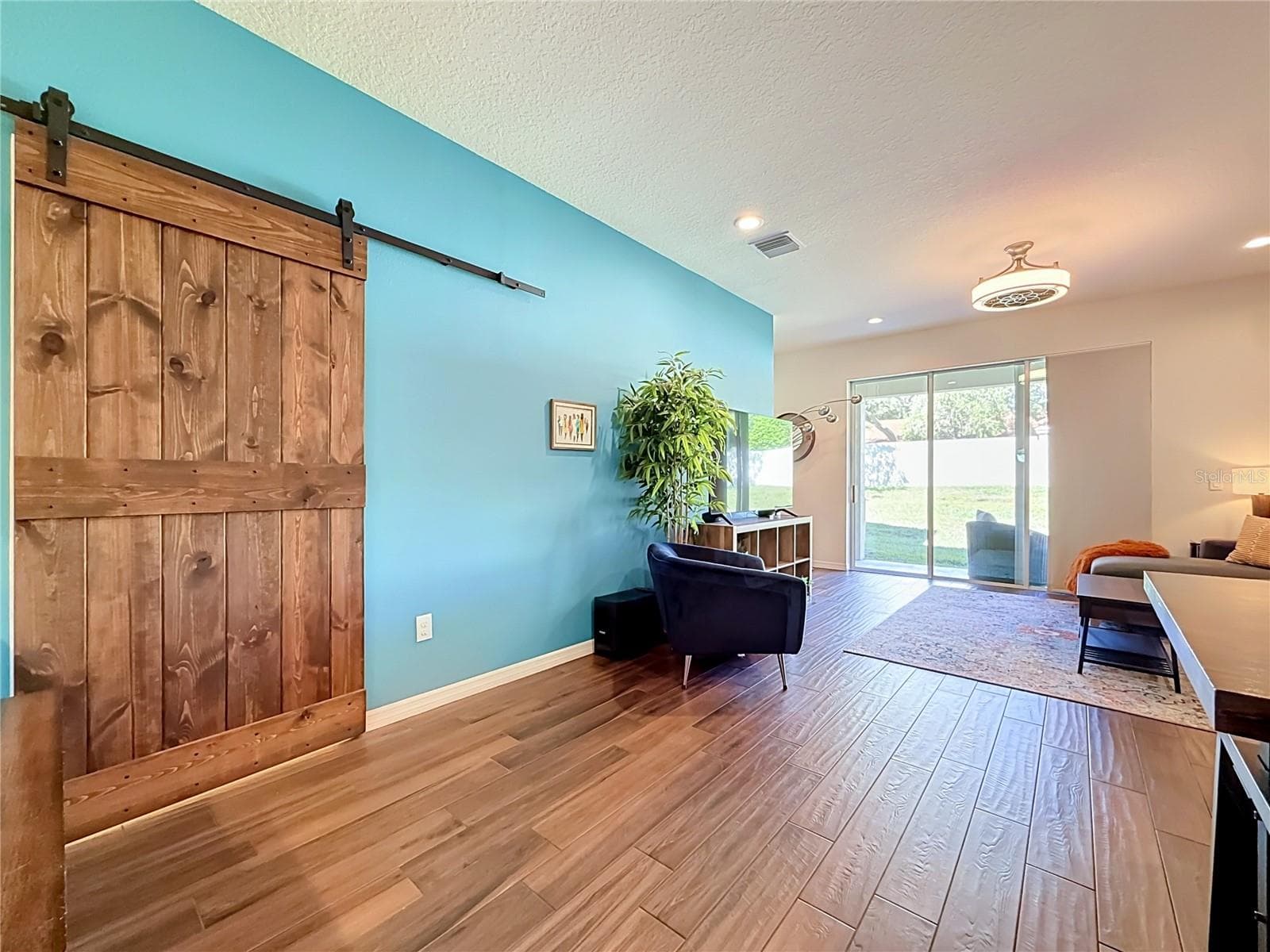 Custom wood barn door adds character to the downstairs half bath - 2270 MONTVIEW DR, CLEARWATER