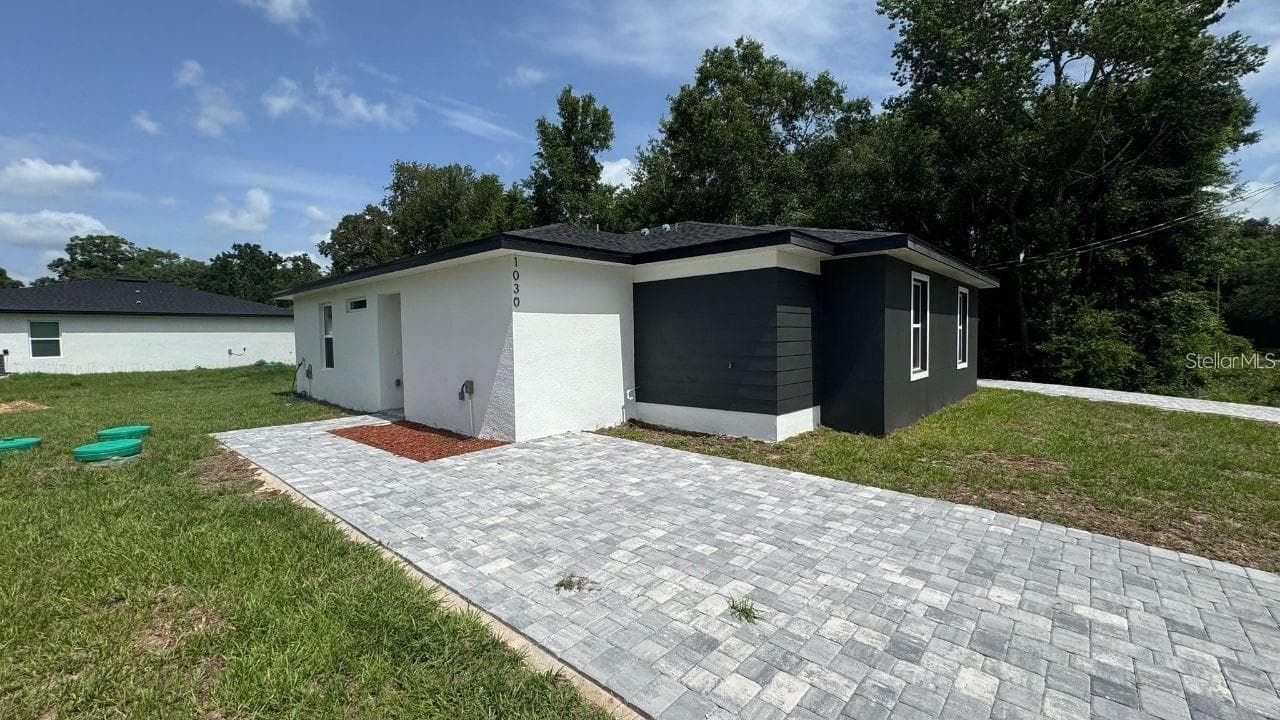 Prior listing photo; may depict a builder model. Verify current property condition. - 1030 NW 57TH CT, OCALA