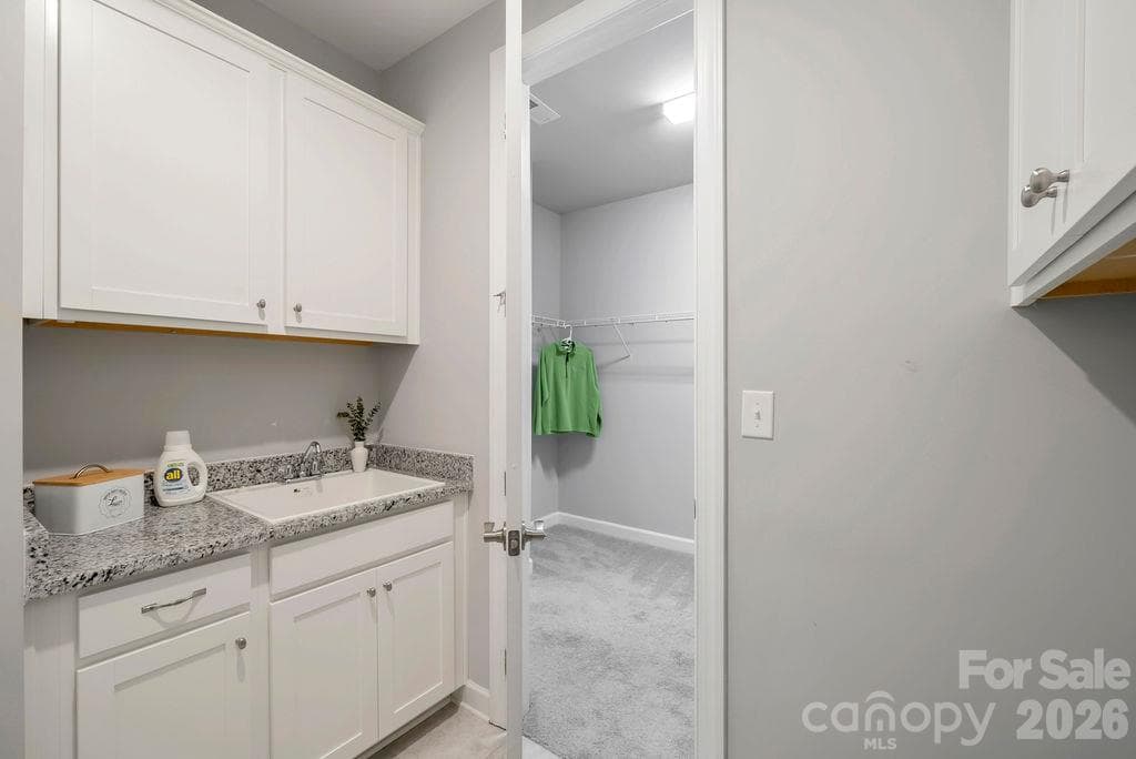 Laundry room with access from Primary Closet and the Hallway - 3232 Marchers Trace Drive, Mint Hill