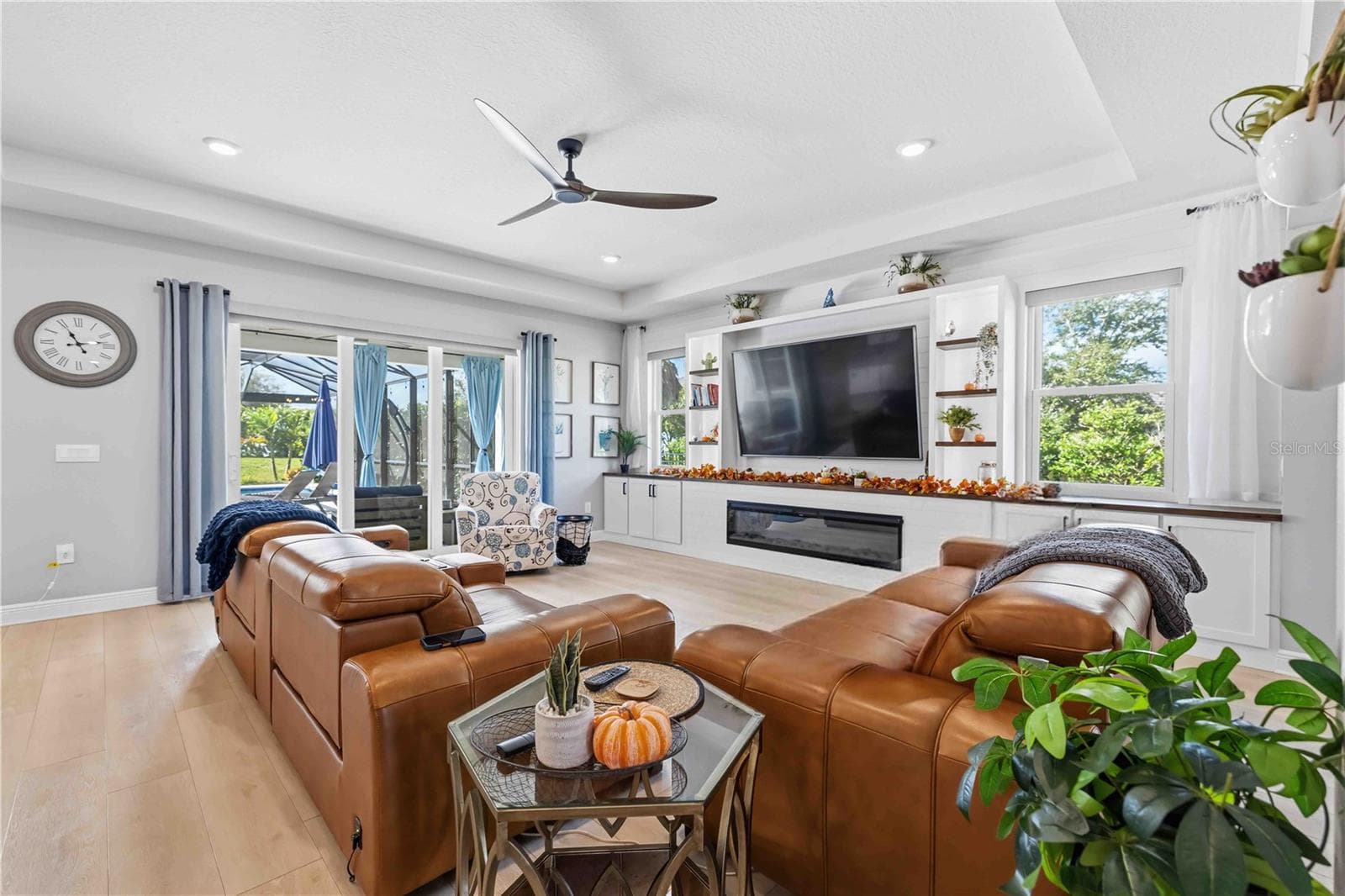 family room with hurricane rated windows + slider and custom built-ins and fireplace - 17604 BARLEY DR, LAKEWOOD RANCH