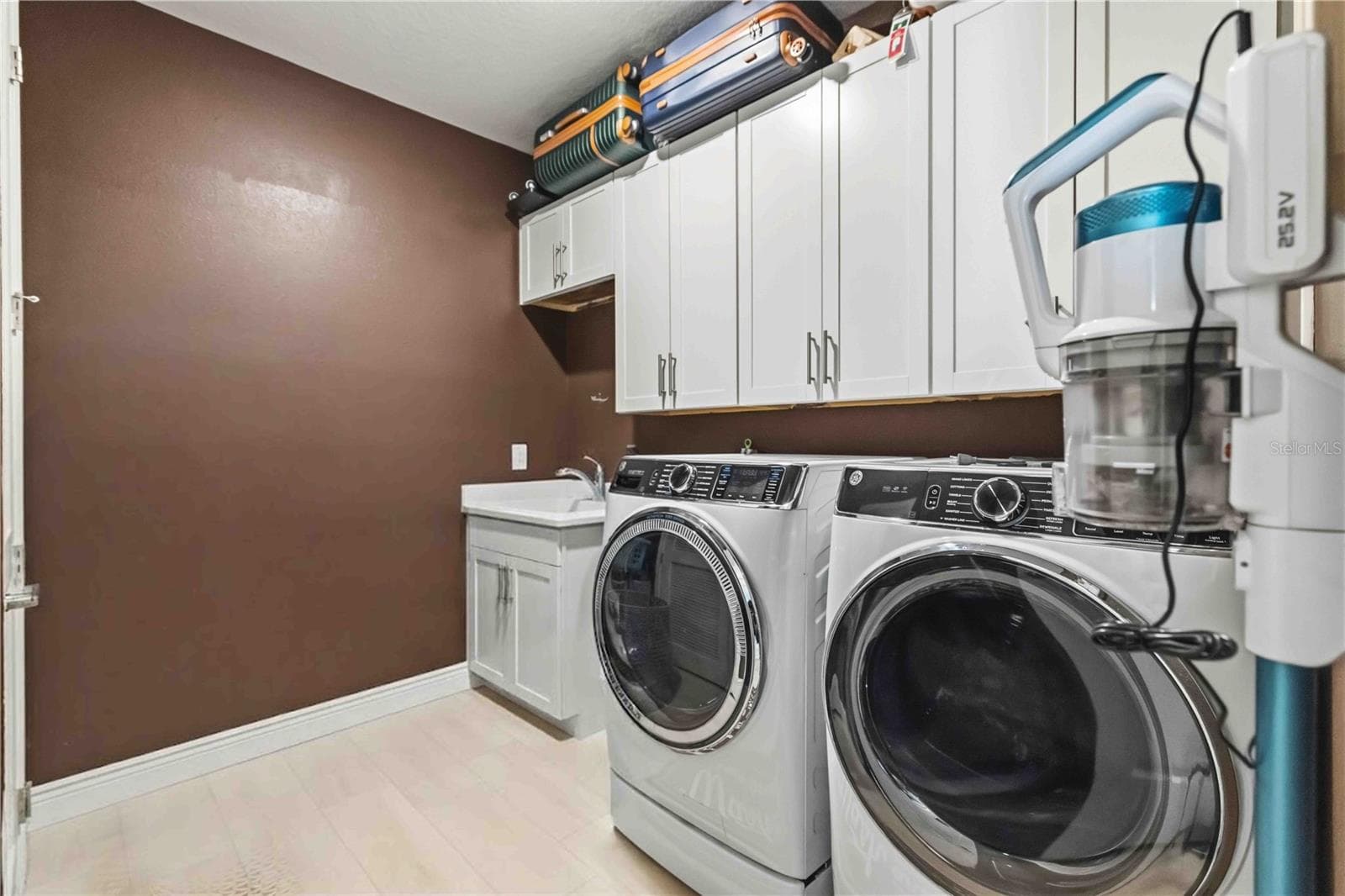 oversized laundry room with cabinetry, sink, storage - 17604 BARLEY DR, LAKEWOOD RANCH