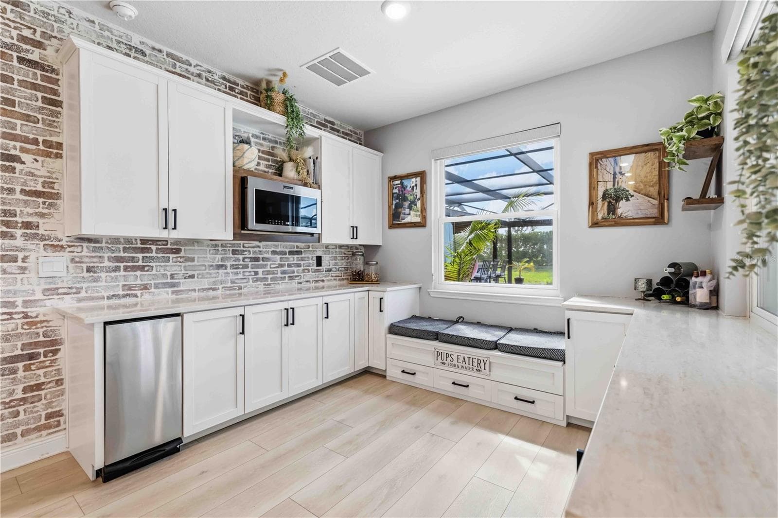 extended kitchen featuring trash compactor, built-in cubbies/seating & microwave - 17604 BARLEY DR, LAKEWOOD RANCH